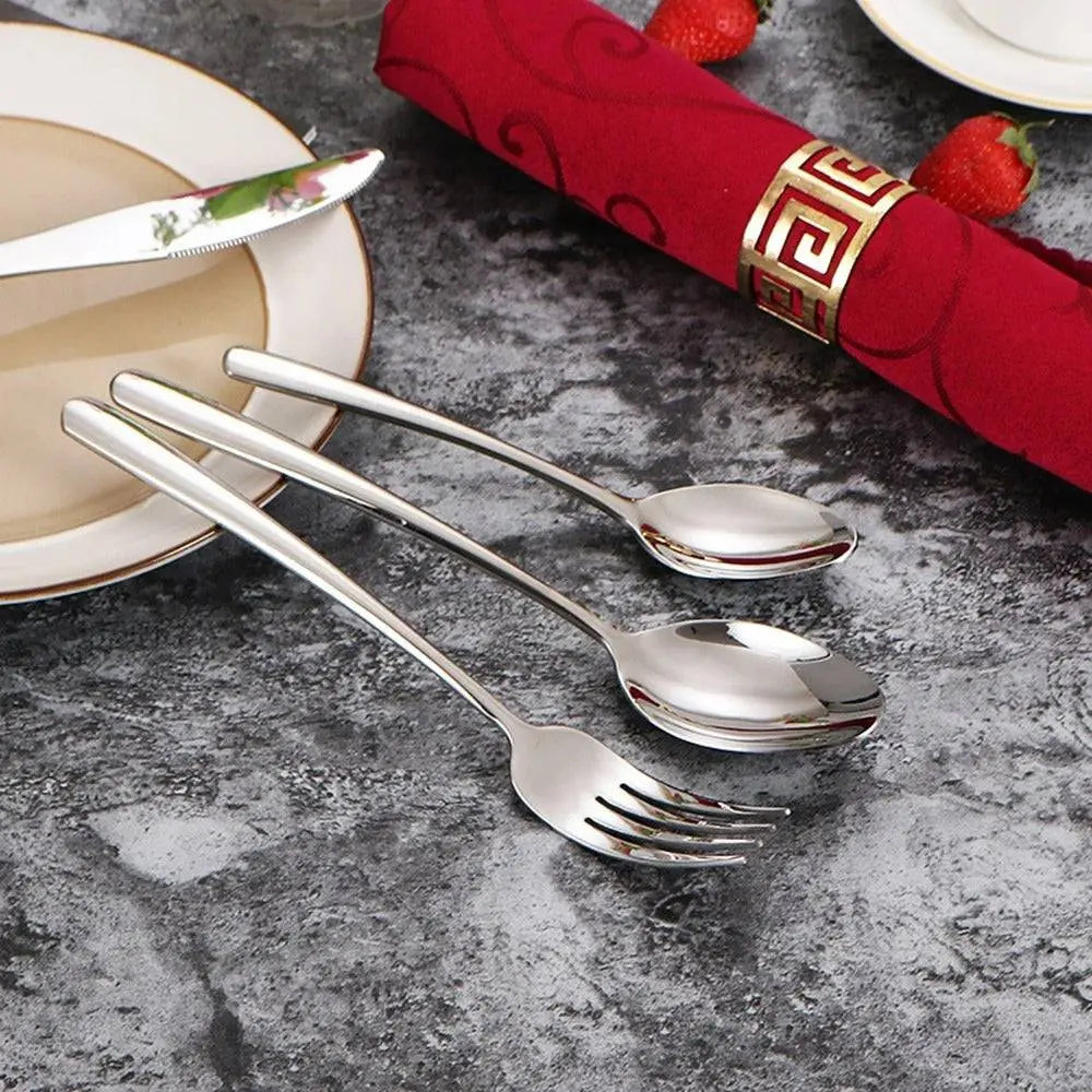 Elegant 304 Stainless Steel Dinnerware Set - Timeless Dining with three utensils displayed beside a red napkin and fine china plate.