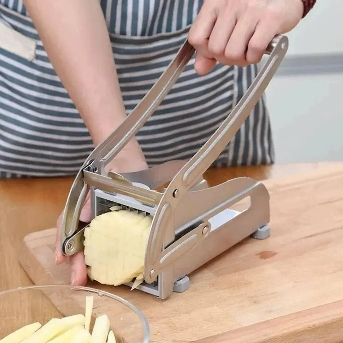 French Fry Cutter - Best Tool for Homemade Fries being used to press a potato through stainless steel blades for perfect homemade fries.