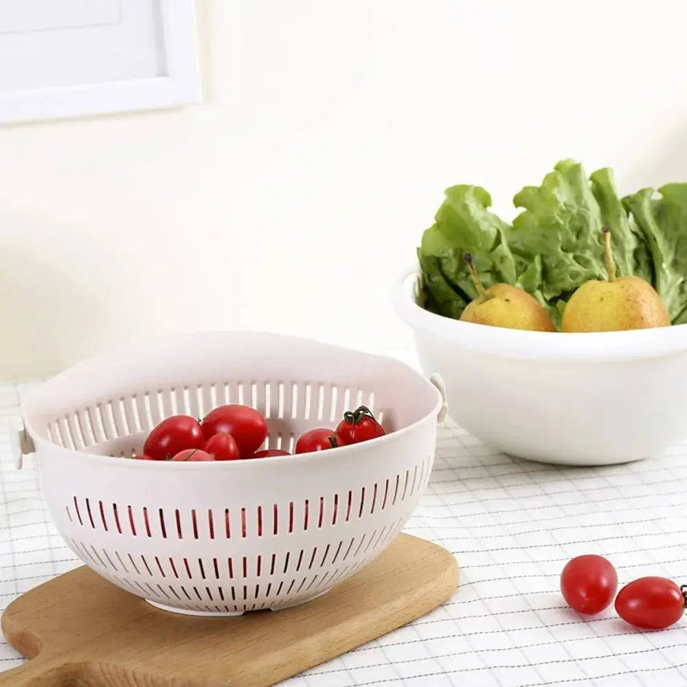 Rotatable Double Drain Basket - Efficient Kitchen Tool filled with tomatoes, placed on a wooden board for kitchen organization.