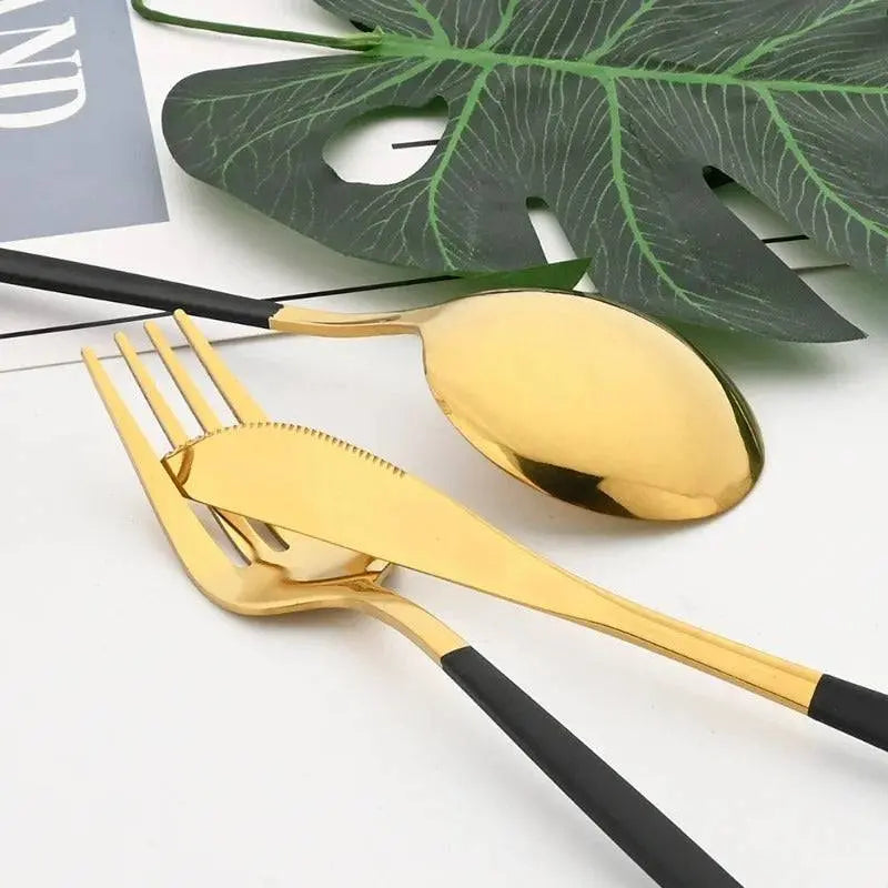 24 Pcs Black Handle Golden Cutlery Set featuring a gold knife, fork, and spoon with sleek black handles, perfect for elegant dining settings.