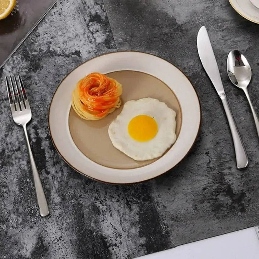 304 Stainless Steel Dinnerware Set - Timeless Dining arranged with a plate of pasta and egg, showcasing the sleek, durable cutlery.