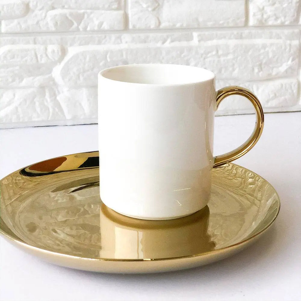 Elegant Coffee Cup with Gold Handle paired with a shiny gold plate, creating a luxurious and refined coffee setting.