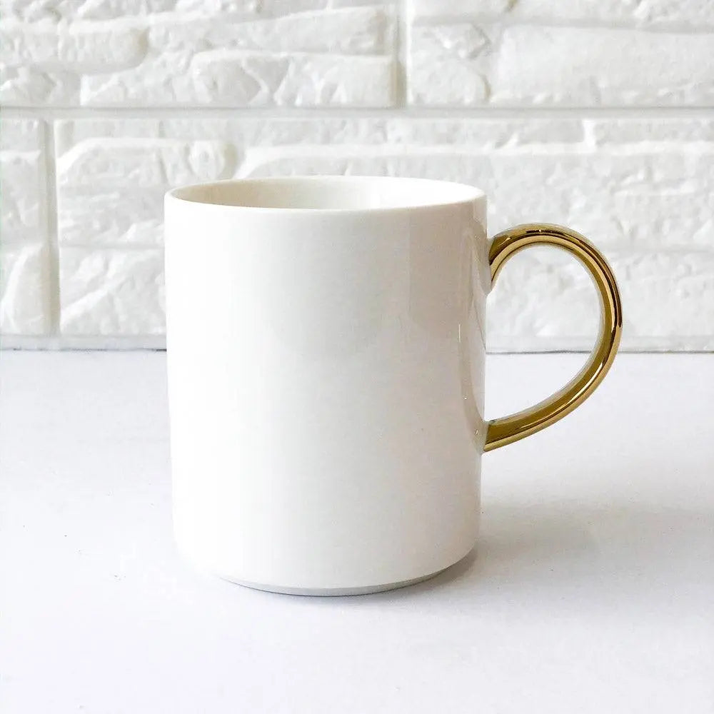 Elegant Coffee Cup with Gold Handle against a white textured background, perfect for a minimalist and elegant coffee setup.
